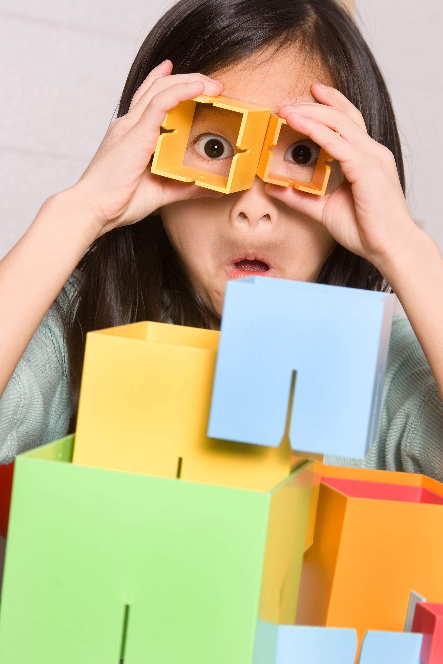 Silly girl playing with cube shapes